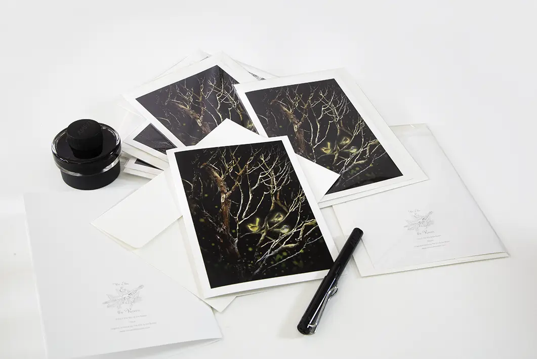 Image of Elm and the Raven original artwork A5 Card Three Little Birds. A trio of small birds sit amongst the bare branches of a tree in the forest. The birds are made magic with a golden glow. Light and stars exist in the deep darkness of the landscape.